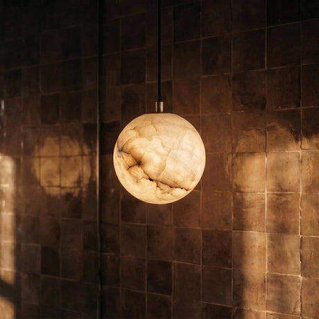 One lit alabaster sphere against a wall of dark glazed tile