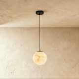 One lit alabaster sphere on a black cord below a small black ceiling plate