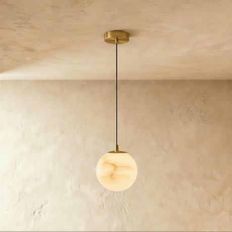 One lit alabaster sphere on a cord below a small brass ceiling plate