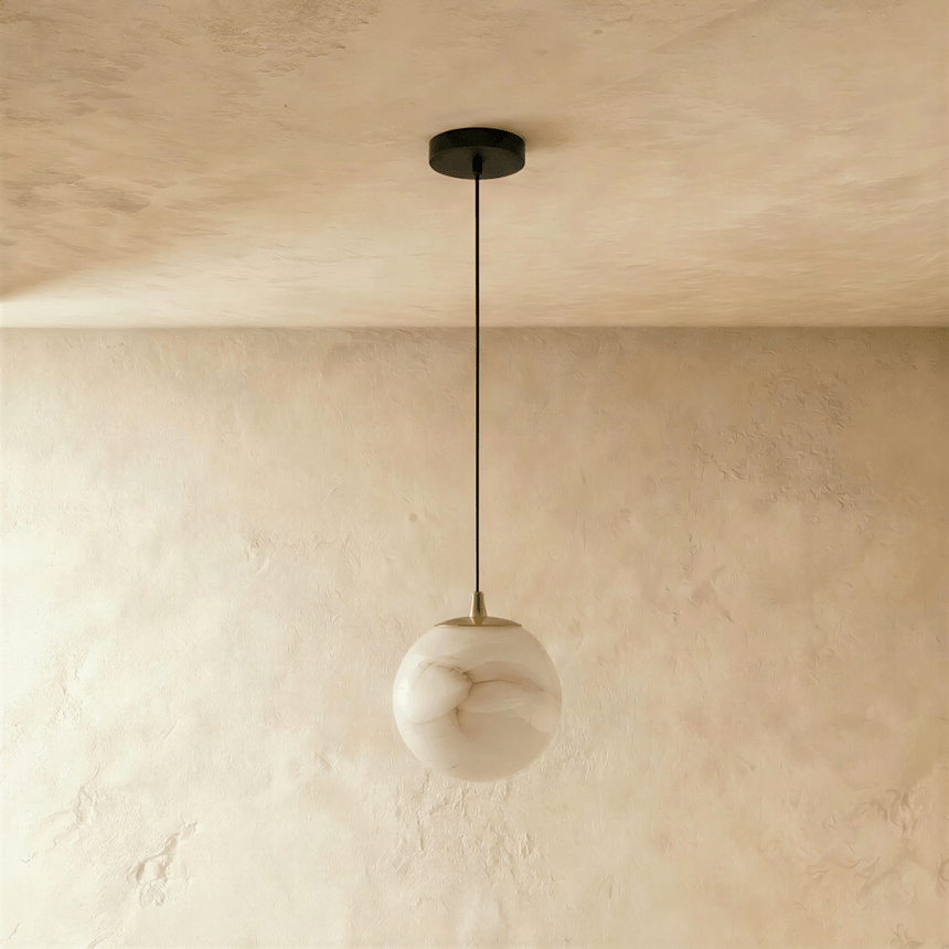 The same alabaster sphere unlit, the veining visible through the pale stone