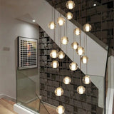 Crystal spheres spiralling beside a glass balustrade in a lit stairwell