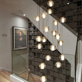 Crystal spheres spiralling beside a glass balustrade in a lit stairwell