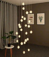 Spheres falling in a living room corner beside framed prints and a chair