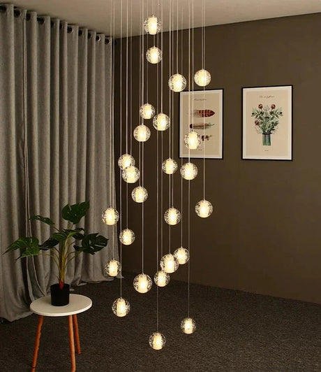 Spheres falling in a living room corner beside framed prints and a chair