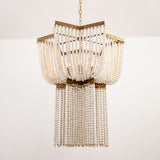 The two tiers of bead strands seen against a pale wall, brass rims between them