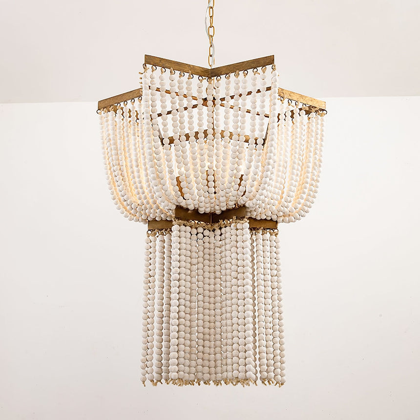The two tiers of bead strands seen against a pale wall, brass rims between them