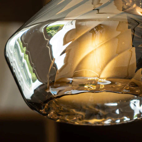 Close view of the amber facets with the lit bulb showing through them