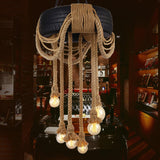 Chandelier lit above a dark bar counter lined with bottles