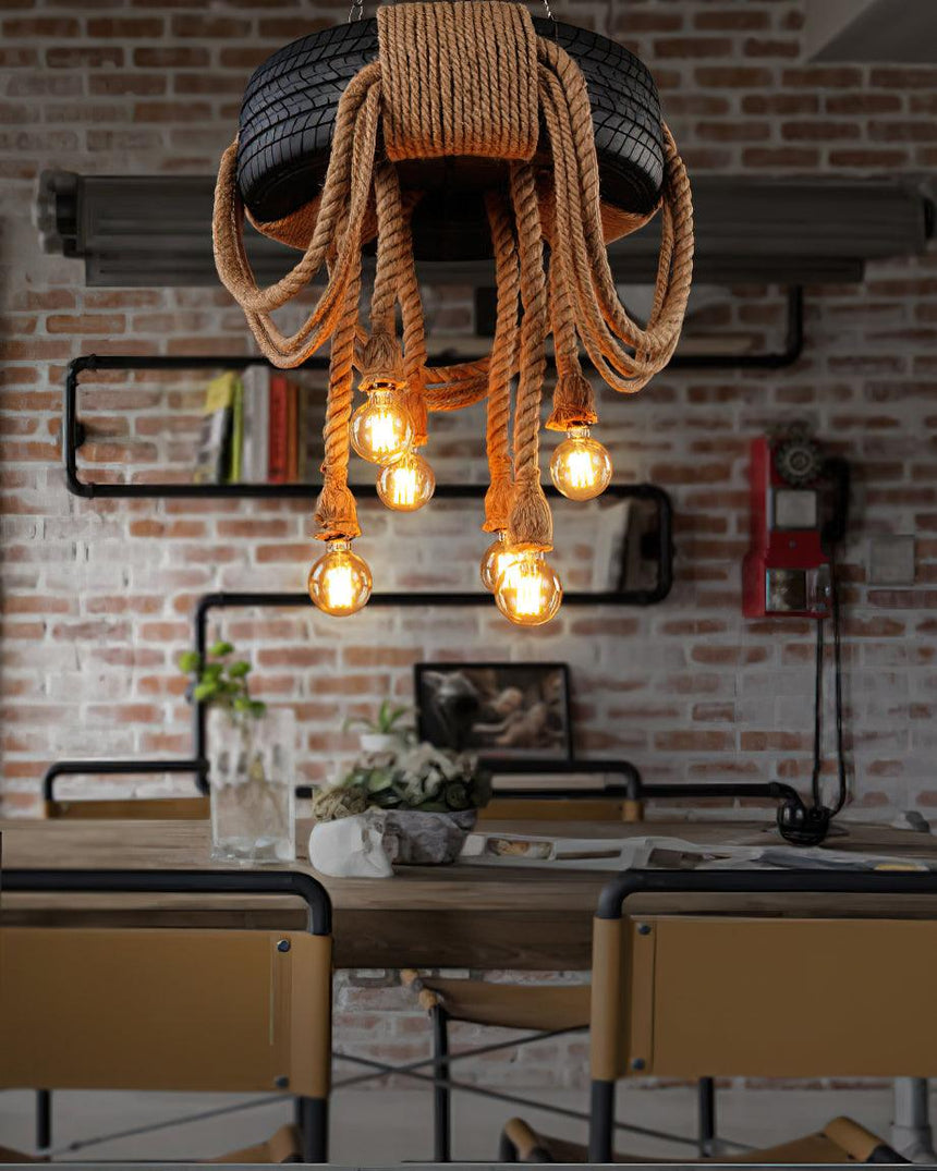 Chandelier lit in front of a brick wall above a steel framed table
