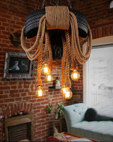 Chandelier lit in a brick room with a framed print and a sofa