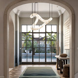 The lit stone tube in an entrance hall under an arch, with a rug and a window