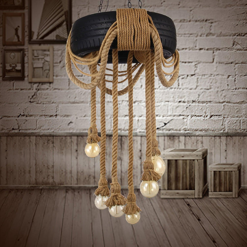 Chandelier lit in a white brick room beside a wood crate and a bench