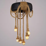 The chandelier lit in full, every strand and lamp visible
