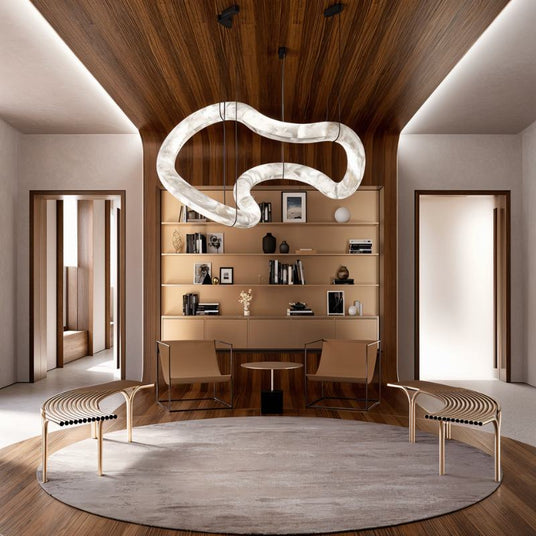 The lit tube above a round rug in a study with shelves, a desk and two chairs
