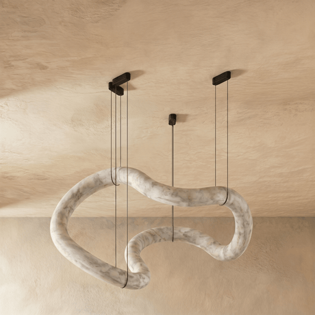 The same winding alabaster tube unlit, the stone pale against plaster