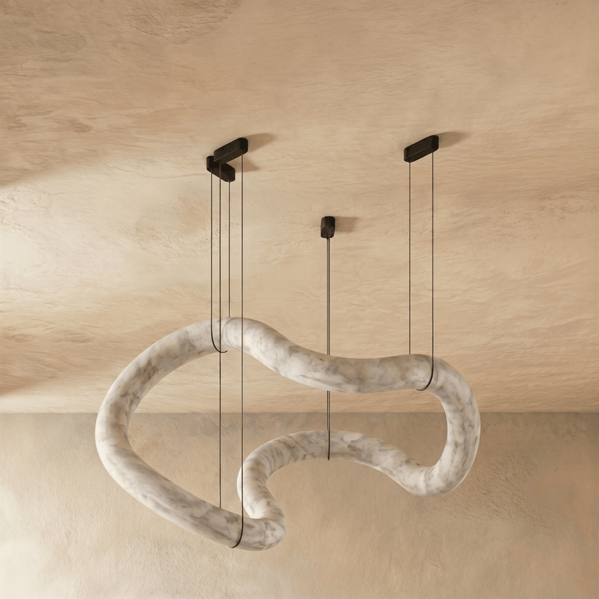 The same winding alabaster tube unlit, the stone pale against plaster