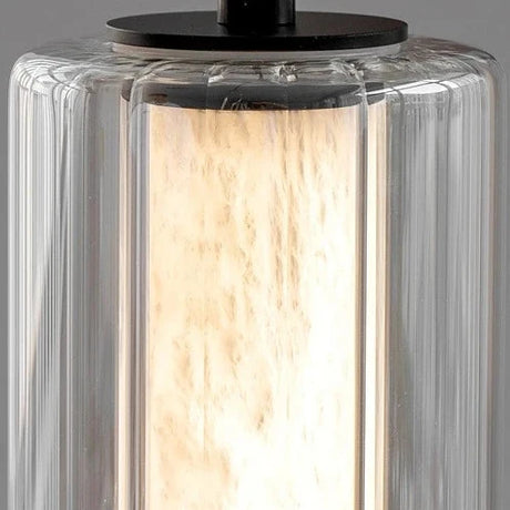 Close view of the clear glass sleeve around the lit marble column