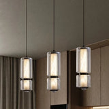 Three marble and glass pendants lit in a row above a counter