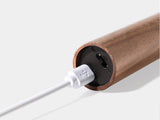 The base of the tube with the charging cable plugged into the port