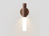 The walnut collar on its round plate, the frosted tube pointing downward