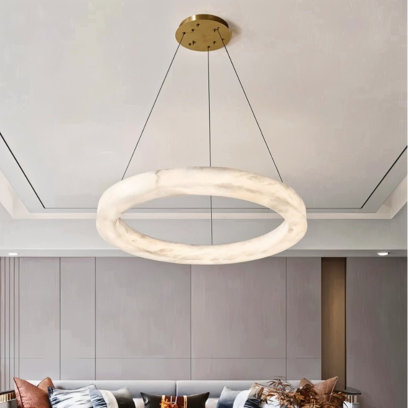 The lit stone ring above a living room with a sofa and a low table
