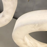 The curved surface of the stone ring, veining running through the alabaster