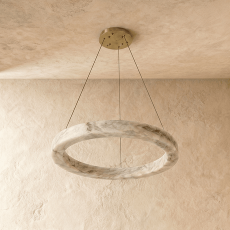 A ring cut from more heavily veined alabaster, unlit on three cables