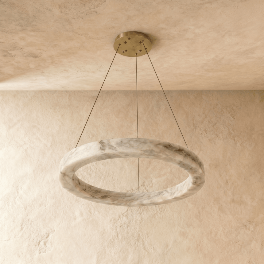 A ring cut from more heavily veined alabaster, unlit on three cables
