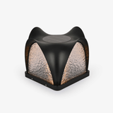 Sculpted cap with four curved petals over textured lit panels