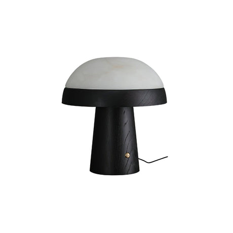 Stone table lamp with a black base against a plain ground