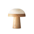 Stone table lamp with a light wood base against a plain ground