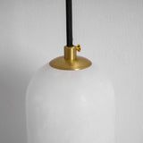 Close view of the brass cap holding the top of the stone shade