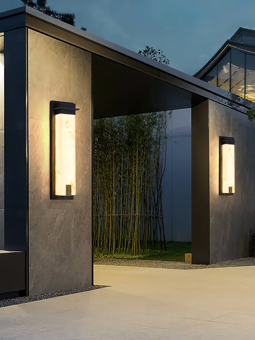 The light lit at a courtyard entry with bamboo planting behind it