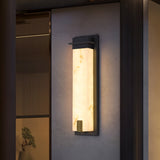 The light on a textured render wall beside a fluted timber panel