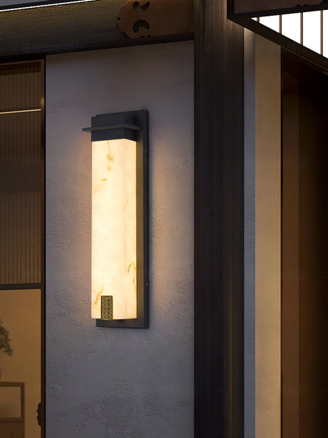 The light on a render wall beside a timber screen and a doorway