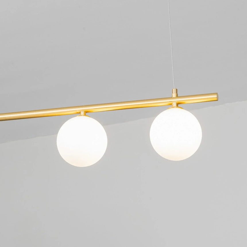 Close view of two opal globes on a brass bar seen from below