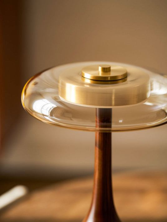 Close view of the brass cap and the amber glass ring, lit