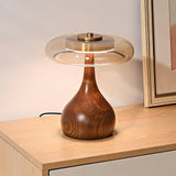 Table lamp with an amber glass shade lit close from the front