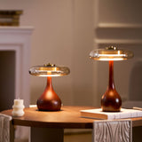 Two table lamps with glass shades lit warm in a pale living room