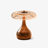 Table lamp with an amber glass shade on a curved walnut base, plain ground
