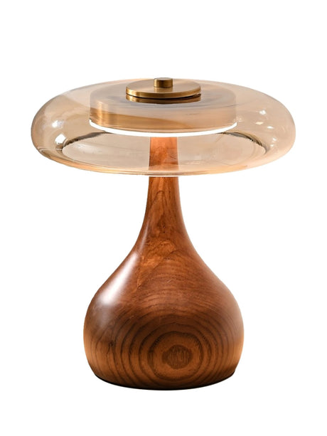 The short glass shade table lamp seen from the front on a plain ground