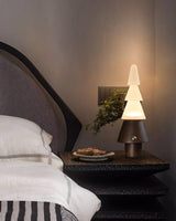 Table lamp with night light lit on a nightstand beside a small tray