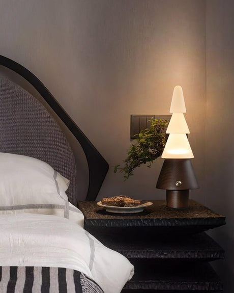 Table lamp with night light lit on a nightstand beside a small tray