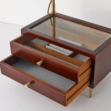 The two lined drawers of the lamp pulled open below the glass top panel