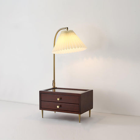 Table lamp with storage switched on against a plain pale background