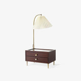Table lamp with storage seen at an angle, the brass arch curving forward