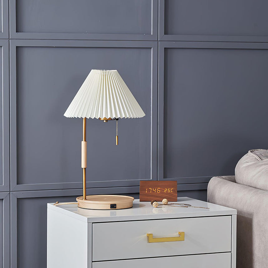 Pleated shade lamp unlit on a nightstand against a paneled wall