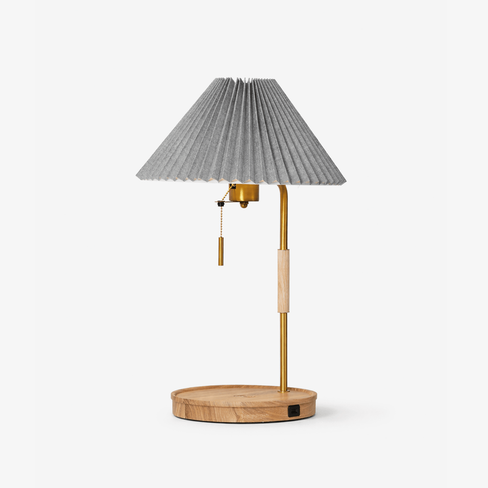 Table lamp with a gray pleated shade on a brass pole and an ash base