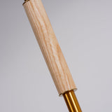 Close view of the wood section of the pole above the brass fitting