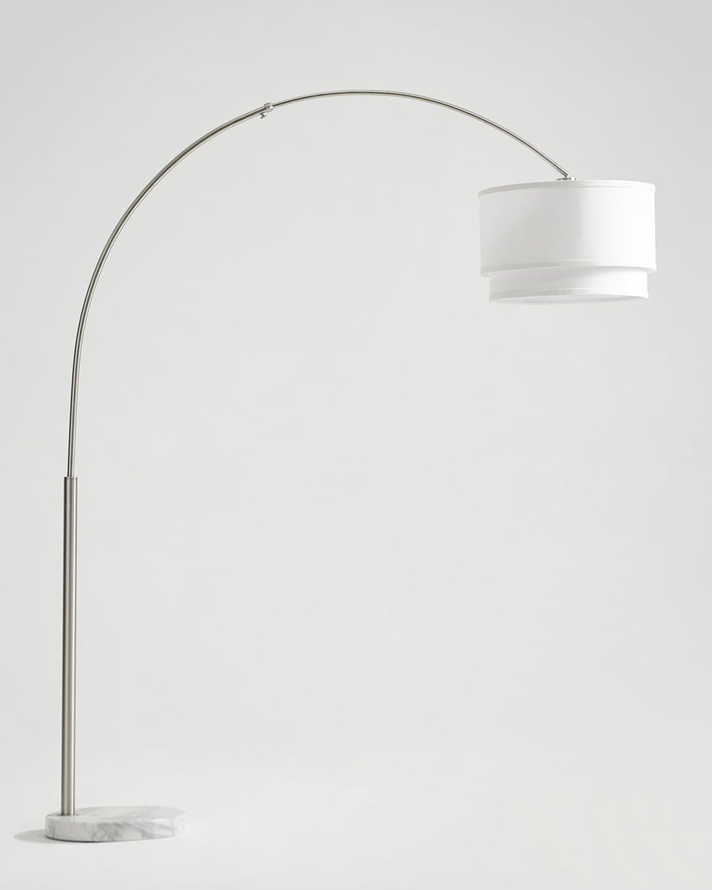 Tall satin nickel arc floor lamp with a two tier white linen shade